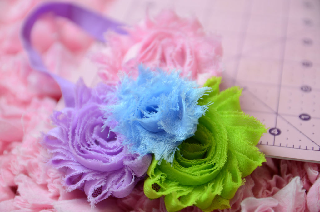Shabby Rose flower headband with pink, lilac, blue,and green on a purple headband - Pretty's Bowtique
