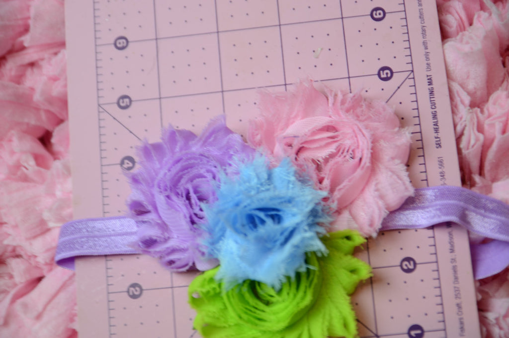 Shabby Rose flower headband with pink, lilac, blue,and green on a purple headband - Pretty's Bowtique
